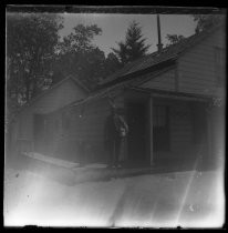 Man standing with parcel in front of office