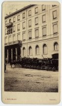 Horse-drawn carriages parked outside Hotel Drei Könige