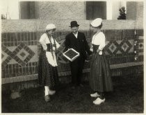 Women in clogs with box of prunes