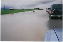 Cars traveling along flooded road