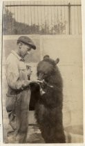 Irvin B. Fisher feeding Dixie the bear