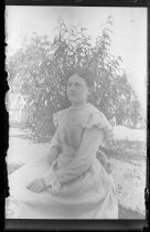Woman seated outside, with lace collar and cuffs