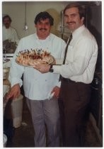 Tom Muller with chef and shrimp cocktail platter at Lou's Village