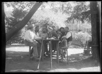 Group of men at table with rifles