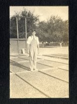 Man standing with drying apricots