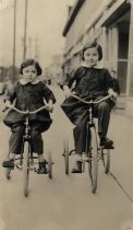 Lenore Maxwell (age 7) and Joyce Maxwell (age 4) on tricycles