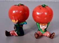 Kids holding tomatoes salt & pepper shakers