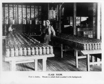 "Glass Room. Fruit in bottles. Retorts in which fruit is cooked in the background."