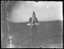 Adult in costume, standing in a field