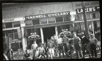 Men posing outside Maxwell Cyclery, Bisceglia Building
