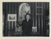 Ruby Levin posing with mounted goat in cabin