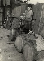 Man pouring syrup into barrel
