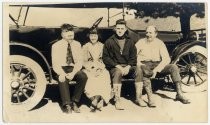 Group portrait seated on automobile