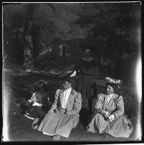 Group posed on lawn, in front of barn