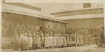 Cannery workers standing outside warehouse