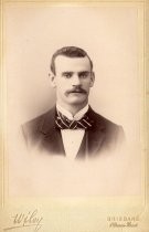 Portrait of young man with mustache and striped bowtie