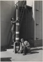 William W. Eitel and Jack A. McCullough, outside with large power tube, ca 1955