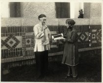 Women holding box of prunes