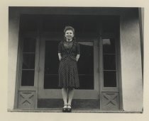 Ruby Levin posing at top of stair in polka-dot dress