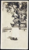 Young woman in hat, holding ball