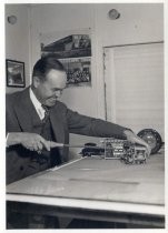 Harold Elliott posing with his clock control for radio