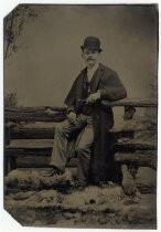 Portrait of man in bowler hat and coat