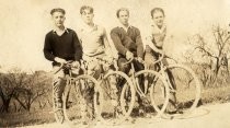 Four cyclists with bikes on country road