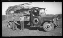 Two men with a Southern Lumber truck loaded with lumber