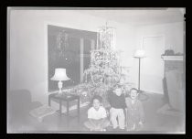 Children in front of Christmas tree, c. 1940