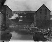 Industrial buildings connected by bridge, c. 1912