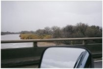 Bridge overlooking flooded river, view from car