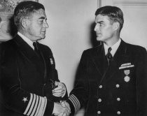 Hugh Stuart Center shaking hand of U.S. Navy officer