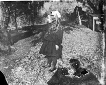 Young girl with ribbon in her hair, outdoors, c. 1912