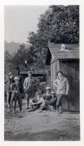 Group of men in front of cabins