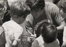 Johnny Moore signs autographs for young fans