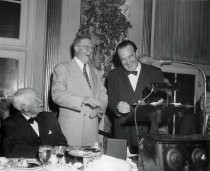 Men laughing at awards ceremony