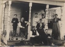 Portrait of family on clapboard house porch