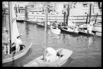 Sailors on boats at marina