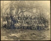 Group portrait of men seated outdoors