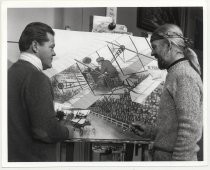 Artist in front of his painting of Roy Francis