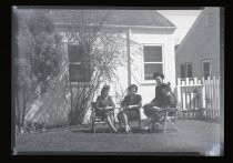 Four women meeting outside a house