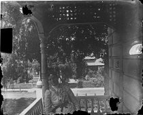 Woman seated on porch, c. 1912