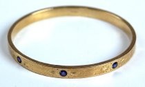 Gold bracelet with blue stones