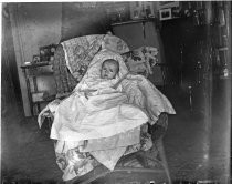 Infant in wicker chair, c. 1912