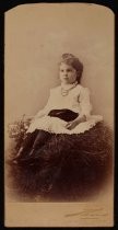 Portrait of girl seated on "hay bale"