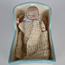 Baby doll in cradle