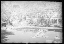 Sunbathers on lawn below resort building