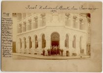 Group portrait of men on steps of First National Bank