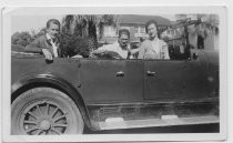 Bohnett family members sitting in four door convertible