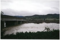 Bridge over high flowing river. Possibly the 1998 El Nino Flood in California